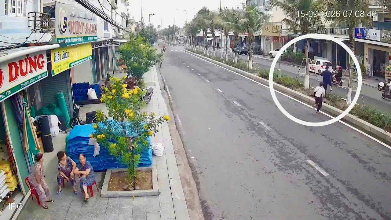 Security camera still: two people running to a car waiting across the road